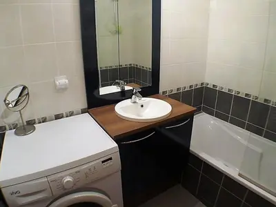 a bathroom with a sink and a washing machine at 3 pièces calme à Samoëns avec parking privé, 4 couchages - FR-1-629-48 in Samoëns
