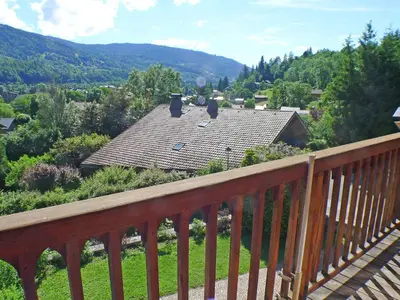 a wooden balcony with a view of a house at Appartement 3 pièces avec balcon et parking à Samoëns - FR-1-629-52 in Samoëns