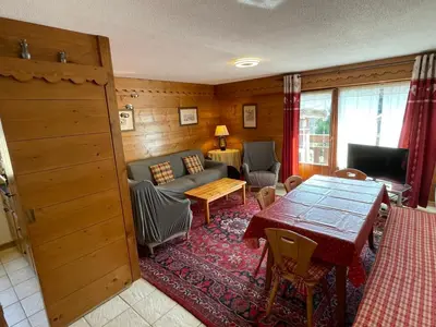 a living room with a table and a couch at Appartement 3 pièces à Samoëns, 6 pers., WIFI, Parking - FR-1-629-76 in Samoëns