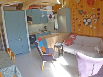 a living room with a couch and a kitchen at Charmant T3 calme à 500m du centre de Samoëns avec parking - FR-1-629-57 in Samoëns