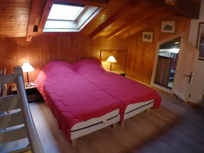 a large red bed in a room with a window at Charmant T3 calme à 500m du centre de Samoëns avec parking - FR-1-629-57 in Samoëns