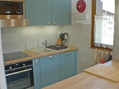 a kitchen with blue cabinets and a sink at Charmant T3 calme à 500m du centre de Samoëns avec parking - FR-1-629-57 in Samoëns