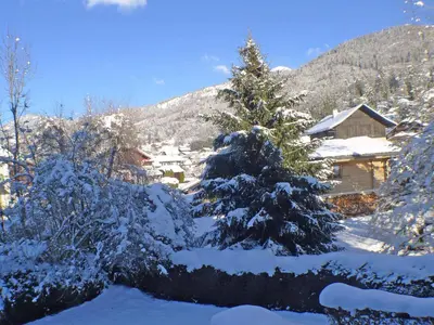 a cabin covered in snow in a yard at Studio cosy centre village, animaux admis, parking privatif - FR-1-629-66 in Samoëns