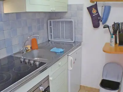 a kitchen with a table and a dining room at Appartement T2 avec mezzanine au cœur du village, animaux admis - FR-1-629-68 in Samoëns