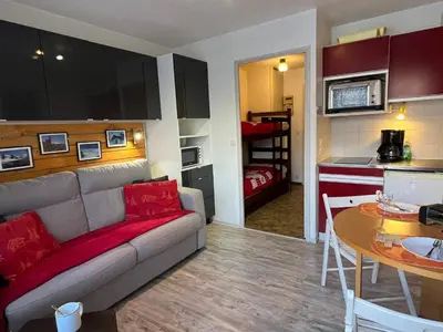 a living room with a couch and a table and a kitchen at Studio cosy au centre de Samoëns, 4 pers, proche commodités - FR-1-629-65 in Samoëns