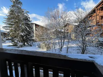 a snow covered yard with trees and a building at Studio cosy au centre de Samoëns, 4 pers, proche commodités - FR-1-629-65 in Samoëns
