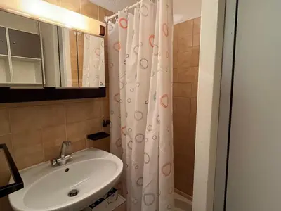a bathroom with a sink and a shower curtain at Studio cosy au centre de Samoëns, 4 pers, proche commodités - FR-1-629-65 in Samoëns