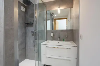 a bathroom with a sink and a shower at La Cordee 703 Apartment - Chamonix All Year in Chamonix-Mont-Blanc