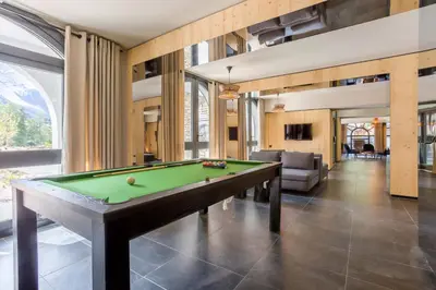 a living room with a pool table in it at La Cordee 703 Apartment - Chamonix All Year in Chamonix-Mont-Blanc