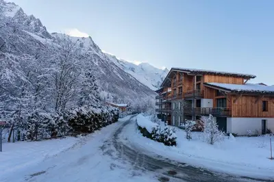 a snow covered road in front of a lodge at La Cordee 703 Apartment - Chamonix All Year in Chamonix-Mont-Blanc