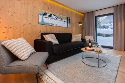 a living room with a couch and a table at La Cordee 703 Apartment - Chamonix All Year in Chamonix-Mont-Blanc