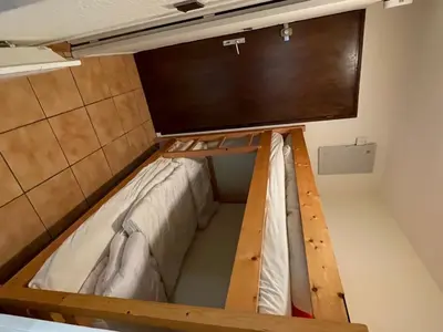 a bed in a room with a tv on the wall at Studio calme pour 4 pers. avec terrasse à Samoëns - FR-1-629-30 in Samoëns