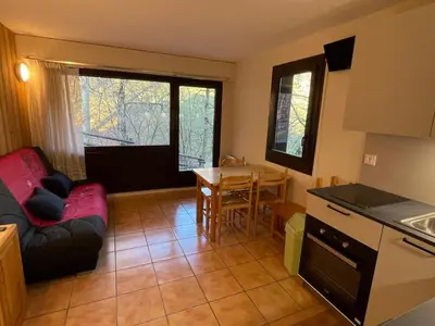 a kitchen and living room with a couch and a table at Studio calme pour 4 pers. avec terrasse à Samoëns - FR-1-629-30 in Samoëns