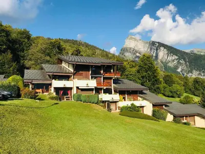 a house on a hill with a mountain in the background at Studio calme pour 4 pers. avec terrasse à Samoëns - FR-1-629-30 in Samoëns