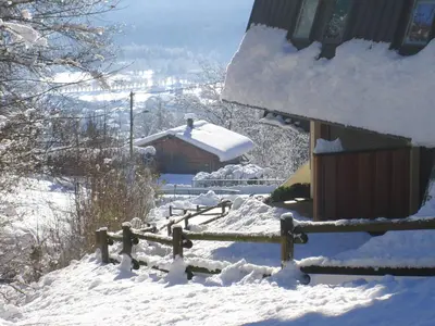 a snow covered yard with a fence and a house at Studio calme pour 4 pers. avec terrasse à Samoëns - FR-1-629-30 in Samoëns
