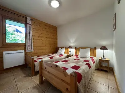 a bedroom with two beds and a window at Appartement T3 cosy avec balcon au centre de Samoëns - FR-1-624-31 in Samoëns