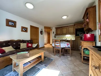 a living room with a couch and a table at Appartement T3 cosy avec balcon au centre de Samoëns - FR-1-624-31 in Samoëns