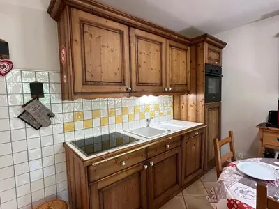 a kitchen with wooden cabinets and a sink at Appartement T3 cosy avec balcon au centre de Samoëns - FR-1-624-31 in Samoëns