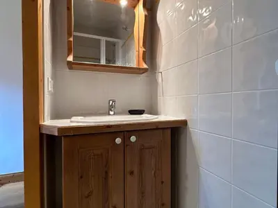 a bathroom with a sink and a mirror at Appartement T3 cosy avec balcon au centre de Samoëns - FR-1-624-31 in Samoëns