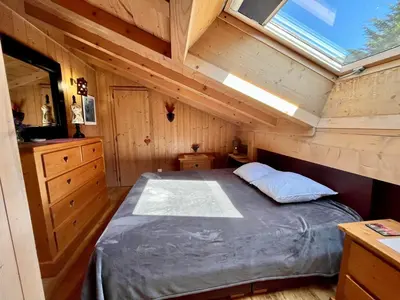a bedroom with a bed in a room with a window at Appartement moderne 3 chambres avec balcon à Samoëns - FR-1-624-25 in Samoëns