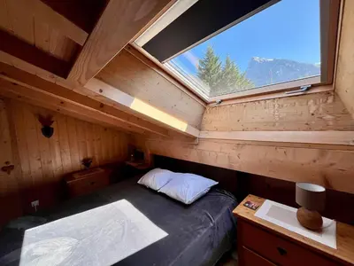 a bedroom with a bed in a room with a window at Appartement moderne 3 chambres avec balcon à Samoëns - FR-1-624-25 in Samoëns