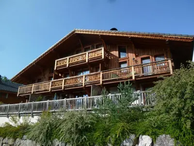 a large wooden house with balconies on a mountain at Appartement moderne 3 chambres avec balcon à Samoëns - FR-1-624-25 in Samoëns