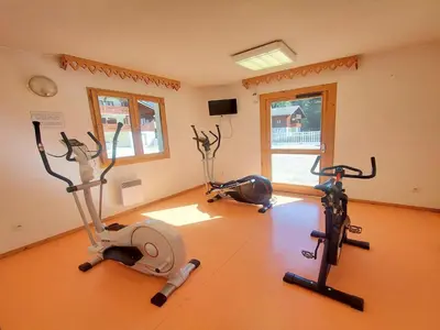 a gym with two exercise bikes in a room at Appartement calme avec piscines chauffée et extérieure - FR-1-624-29 in Samoëns