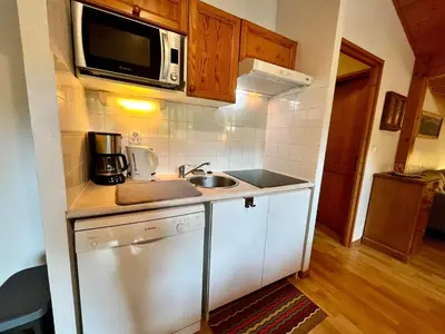 a small kitchen with a sink and a microwave at Appartement calme avec piscines chauffée et extérieure - FR-1-624-29 in Samoëns