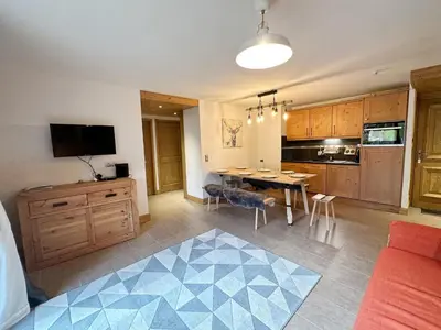 a living room with a kitchen and a dining room at Charmant T3 au cœur de Samoëns avec jardin, parking et proche ski-bus - FR-1-624-16 in Samoëns