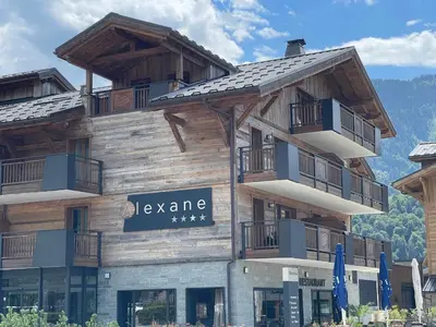 a large wooden building with a sign on it at Charmant T3 au cœur de Samoëns avec jardin, parking et proche ski-bus - FR-1-624-16 in Samoëns