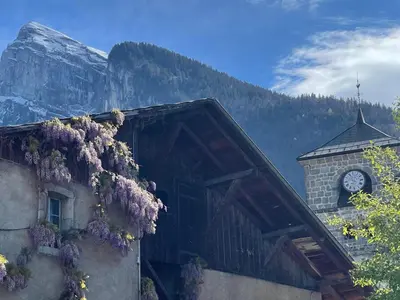 a building with purple flowers on the side of it at Charmant T3 au cœur de Samoëns avec jardin, parking et proche ski-bus - FR-1-624-16 in Samoëns