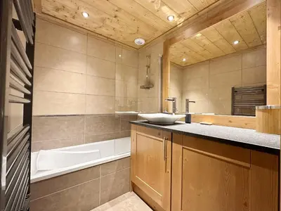 a bathroom with a sink and a bath tub at Charmant T3 au cœur de Samoëns avec jardin, parking et proche ski-bus - FR-1-624-16 in Samoëns