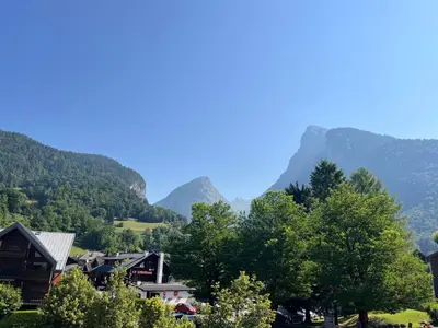 a village in the mountains with mountains in the background at Appartement T2 au cœur du village avec parking - FR-1-624-20 in Samoëns