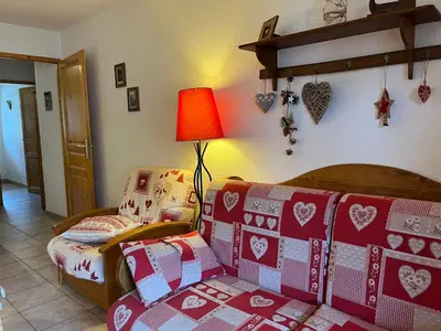 a living room with a couch and a lamp with presents at Bel Appartement Central avec Terrasse en Plein Cœur de Samoëns - FR-1-624-19 in Samoëns