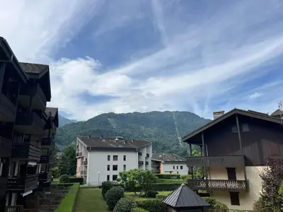 a group of buildings with mountains in the background at Bel Appartement Central avec Terrasse en Plein Cœur de Samoëns - FR-1-624-19 in Samoëns