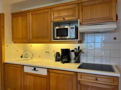 a kitchen with a sink and a microwave at Bel Appartement Central avec Terrasse en Plein Cœur de Samoëns - FR-1-624-19 in Samoëns