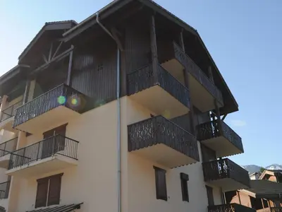 a building with balconies on the side of it at Bel Appartement Central avec Terrasse en Plein Cœur de Samoëns - FR-1-624-19 in Samoëns