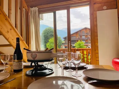 a table with wine glasses and a pan on it at Duplex chaleureux près télécabine, balcon & WIFI - FR-1-624-33 in Samoëns