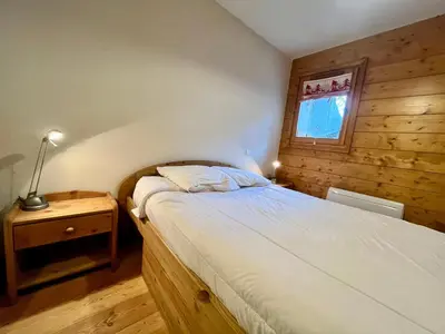 a small bedroom with a bed and a window at Appartement T3 au cœur de Samoëns avec terrasse et garage - FR-1-624-28 in Samoëns