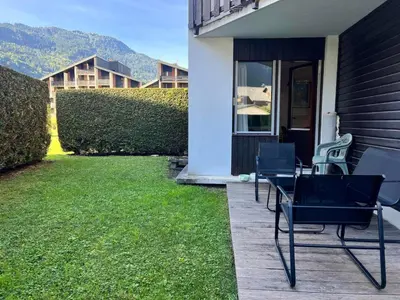 a group of chairs sitting on a patio at Studio lumineux au centre, jardin, parking, casier à skis - FR-1-624-56 in Samoëns