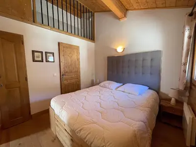 a bedroom with a large bed in a room at Appartement centre village avec balcon et animaux admis - FR-1-624-49 in Samoëns