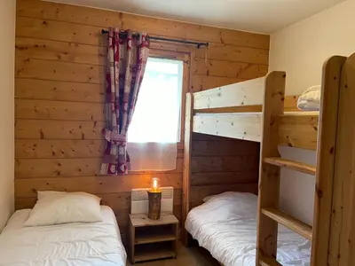 a balcony with a table and a view of a mountain at Appartement centre village avec balcon et animaux admis - FR-1-624-49 in Samoëns