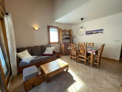 a living room with a couch and a table at Appartement centre village avec balcon et animaux admis - FR-1-624-49 in Samoëns