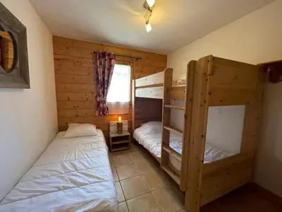 a bedroom with two bunk beds and a window at Appartement centre village avec balcon et animaux admis - FR-1-624-49 in Samoëns