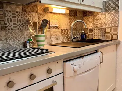 a kitchen with a sink and a counter top at Bel appartement moderne avec balcon et parking - FR-1-624-59 in Samoëns