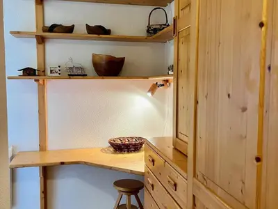 a kitchen with wooden shelves and a wooden desk at Bel appartement moderne avec balcon et parking - FR-1-624-59 in Samoëns