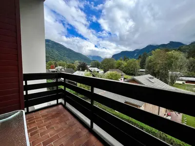 a balcony with a view of the mountains at Bel appartement moderne avec balcon et parking - FR-1-624-59 in Samoëns