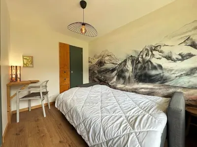 a bedroom with a bed and a painting on the wall at Cosy appartement avec jardin privé et WIFI à Samoëns - FR-1-624-47 in Samoëns