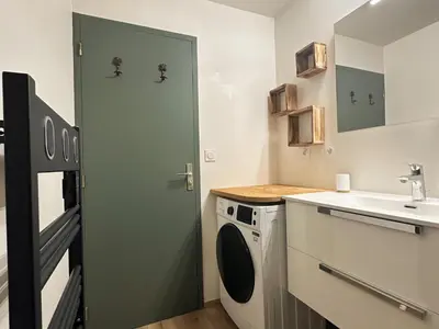 a small kitchen with a sink and a washing machine at Cosy appartement avec jardin privé et WIFI à Samoëns - FR-1-624-47 in Samoëns