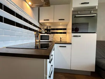 a kitchen with white cabinets and a microwave at Studio cosy aux pieds des pistes, vue splendide - FR-1-624-53 in Samoëns